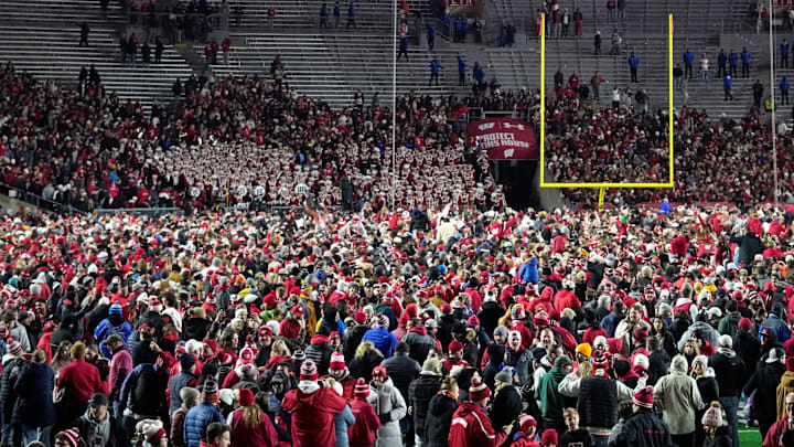 Wisconsin Badgers fans storm the field after a 27-10 win over the Illinois Fighting Illini at Camp Randall Stadium. Wisconsin Badgers fans storm the field after a 27-10 win over the Illinois Fighting Illini at Camp Randall Stadium.