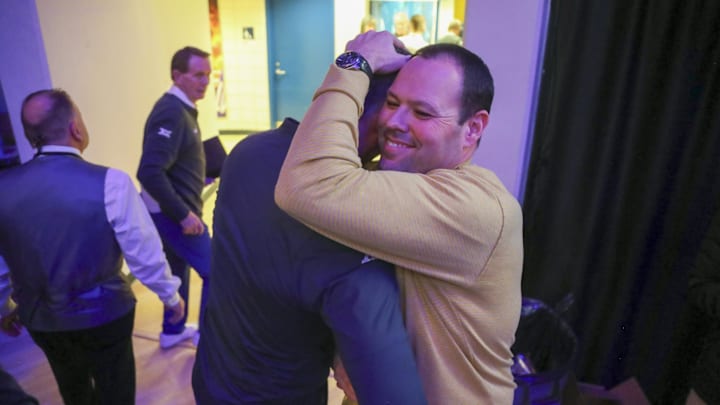 Jan 13, 2024; Morgantown, West Virginia, USA; West Virginia Mountaineers head coach Josh Eilert celebrates with West Virginia Mountaineers Athletic Director Wren Baker after defeating the Texas Longhorns at WVU Coliseum. Mandatory Credit: Ben Queen-Imagn Images