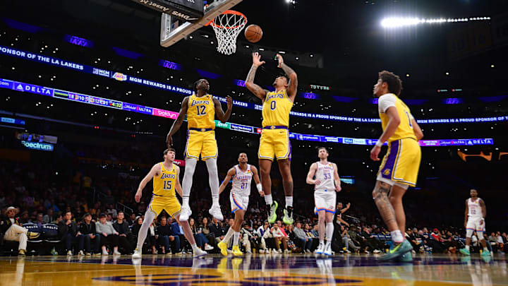 Mar 4, 2024; Los Angeles, California, USA; Los Angeles Lakers guard Jalen Hood-Schifino (0) plays for the rebound agianst the Oklahoma City Thunder during the second half at Crypto.com Arena. Mandatory Credit: Gary A. Vasquez-Imagn Images
