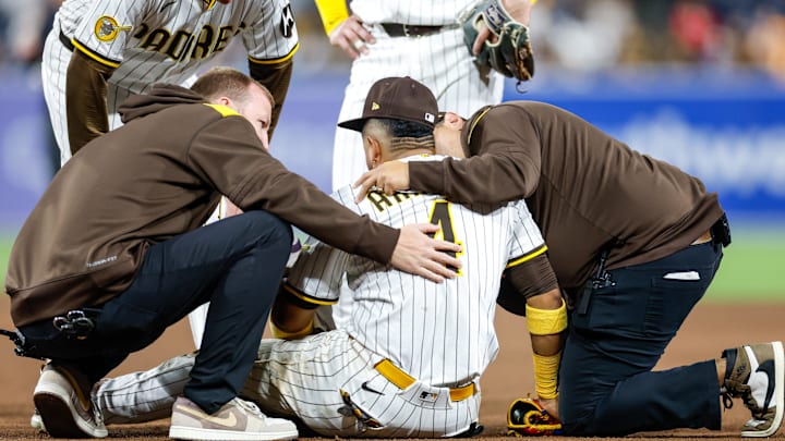 Sep 13, 2025; San Diego, California, USA; San Diego Padres second baseman Luis Arraez (4) is looked at by the training staff during the ninth inning against the Colorado Rockies at Petco Park. Mandatory Credit: David Frerker-Imagn Images Sep 13, 2025; San Diego, California, USA; San Diego Padres second baseman Luis Arraez (4) is looked at by the training staff during the ninth inning against the Colorado Rockies at Petco Park. Mandatory Credit: David Frerker-Imagn Images