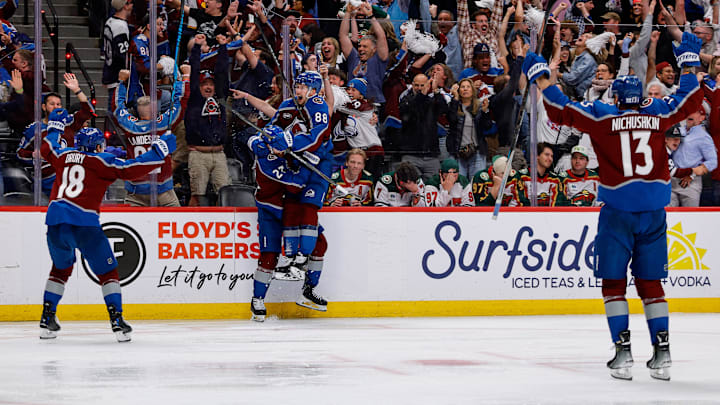 May 13, 2026; Denver, Colorado, USA; Colorado Avalanche defenseman Brett Kulak (27) celebrates his goal with center Martin Necas (88) and center Jack Drury (18) and right wing Valeri Nichushkin (13) in overtime against the Minnesota Wild in game five of the second round of the 2026 Stanely Cup Playoffs at Ball Arena. Mandatory Credit: Isaiah J. Downing-Imagn Images