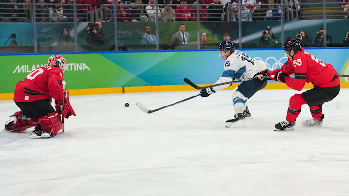 Feb 20, 2026; Milan, Italy; Anton Lundell (15) of Finland takes a shot on Jordan Binnington (50) of Canada during the third period in a men's ice hockey semifinal during the Milano Cortina 2026 Olympic Winter Games at Milano Santagiulia Ice Hockey Arena. Mandatory Credit: James Lang-Imagn Images