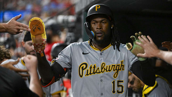 Pittsburgh Pirates center fielder Oneil Cruz (15) is congratulated by teammates after scoring against the St. Louis Cardinals during the eighth inning at Busch Stadium.