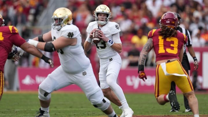 Nov 30, 2024; Los Angeles, California, USA; Notre Dame Fighting Irish quarterback Riley Leonard (13) throws the ball against the Southern California Trojans in the first half at United Airlines Field at Los Angeles Memorial Coliseum. 