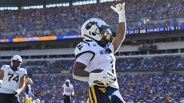 Sep 14, 2024; Pittsburgh, Pennsylvania, USA; West Virginia Mountaineers running back Jahiem White (1) celebrates after scoring a touchdown against the Pittsburgh Panthers during the second quarter at Acrisure Stadium. Mandatory Credit: Barry Reeger-Imagn Images