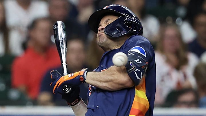 Houston Astros second baseman Jose Altuve (27) is hit by a pitch against the Seattle Mariners in the fifth inning at Daikin Park.