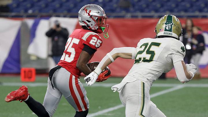 CM’s Christian Simmons makes a nice to move to avoid the tackle of Bishop Feehan’s Kaden Baltazar on his way to the back of the end zone to give CM the 28-7 lead during third quarter action of the Division 2 football championship game between Catholic Memorial and Bishop Feehan at Gillette Stadium in Foxborough on Saturday, December 6, 2025. CM’s Christian Simmons makes a nice to move to avoid the tackle of Bishop Feehan’s Kaden Baltazar on his way to the back of the end zone to give CM the 28-7 lead during third quarter action of the Division 2 football championship game between Catholic Memorial and Bishop Feehan at Gillette Stadium in Foxborough on Saturday, December 6, 2025.