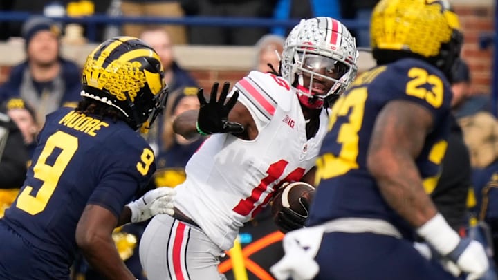 Marvin Harrison Jr. throws a straight-arm to try and escape against rival Michigan. Marvin Harrison Jr. throws a straight-arm to try and escape against rival Michigan.