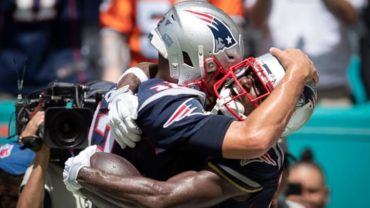 Tom Brady and Antonio Brown embrace.