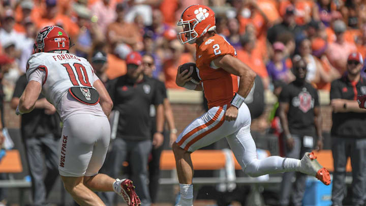 Sep 21, 2024; Clemson, South Carolina, USA; Clemson Tigers quarterback Cade Klubnik (2) runs for a first down against North Carolina State Wolfpack linebacker Caden Fordham (10) during the second quarter at Memorial Stadium. 