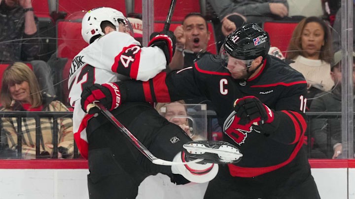 Feb 3, 2026; Raleigh, North Carolina, USA;  Carolina Hurricanes center Jordan Staal (11) checks Ottawa Senators defenseman Tyler Kleven (43) during the first period at Lenovo Center. Mandatory Credit: James Guillory-Imagn Images