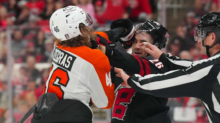 May 2, 2026; Raleigh, North Carolina, USA; Philadelphia Flyers center Trevor Zegras (46) and Carolina Hurricanes defenseman Sean Walker (26) battle during the second period at Lenovo Center. Mandatory Credit: James Guillory-Imagn Images