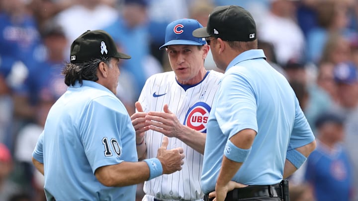 Chicago Cubs manager Craig Counsell argues a call with umpires Phil Cuzzi and Dan Bellino.