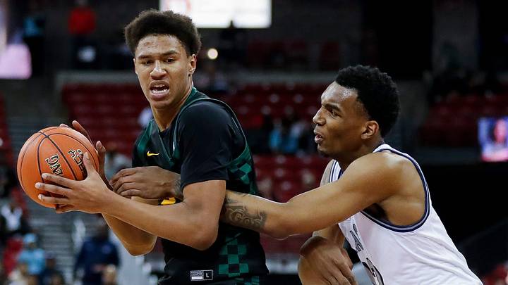 Freedom High School's Donovan Davis (24) is fouled by Milwaukee Academy of Science's Devin Brown (12) during the WIAA Division 3 state championship game on Saturday, March 22, 2025, at the Kohl Center in Madison, Wis. Milwaukee Academy of Science won the game, 57-54.