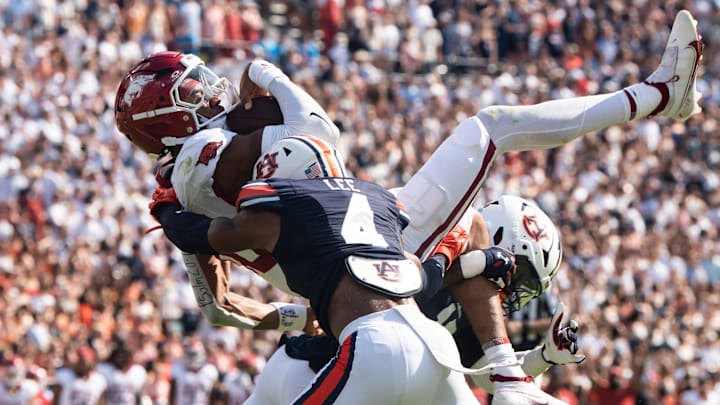 Arkansas Razorbacks quarterback Taylen Green (10) dives at the goal line and is stopped by Auburn Tigers safety Sylvester Smith (19) and defensive back Kayin Lee (4) as Auburn Tigers take on Arkansas Razorbacks at Jordan-Hare Stadium in Auburn, Ala., on Saturday, Sept. 21, 2024. Arkansas Razorbacks lead Auburn Tigers 7-0 at halftime.