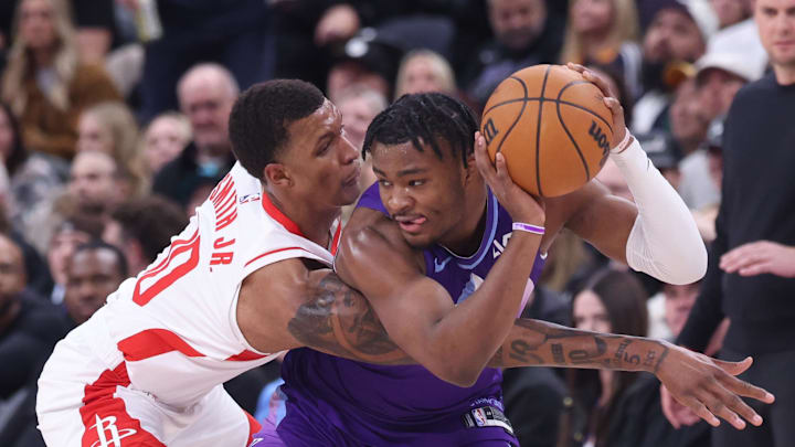 Feb 22, 2025; Salt Lake City, Utah, USA; Houston Rockets forward Jabari Smith Jr. (10) reaches for the ball held by Utah Jazz guard Isaiah Collier (13) during the second half at Delta Center. Mandatory Credit: Rob Gray-Imagn Images