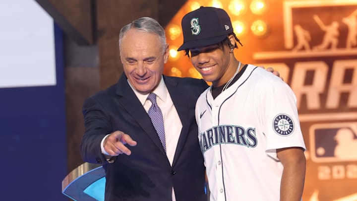 Jul 14, 2024; Ft. Worth, TX, USA;  MLB Commissioner Rob Manfred takes a photo with Jurrangelo Cijntje after being drafted by the Seattle Mariners with the 15th pick during the first round of the MLB Draft at Cowtown Coliseum. Mandatory Credit: Kevin Jairaj-Imagn Images