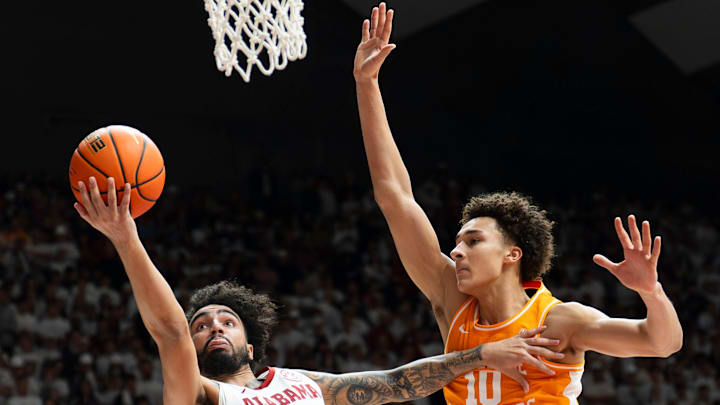 Jan 24, 2026; Tuscaloosa, AL, USA; Alabama guard Houston Mallette (95) scores as he is defended by Tennessee forward Nate Ament (10) at Coleman Coliseum. Mandatory Credit: Gary Cosby Jr.-Tuscaloosa News