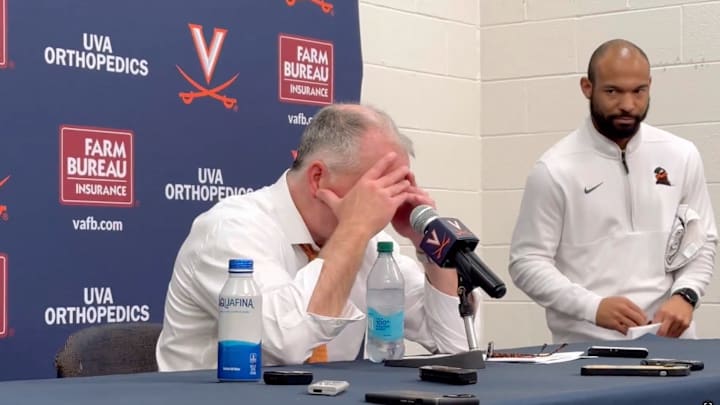 Hokies coach Mike Young buries his head in his hands after a loss of Virginia.
