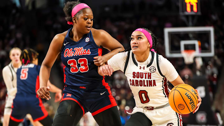 Feb 4, 2024; Columbia, South Carolina, USA; South Carolina Gamecocks guard Te-Hina Paopao (0) drives around Ole Miss Rebels forward Kharyssa Richardson (33) in the first half at Colonial Life Arena. Mandatory Credit: Jeff Blake-Imagn Images