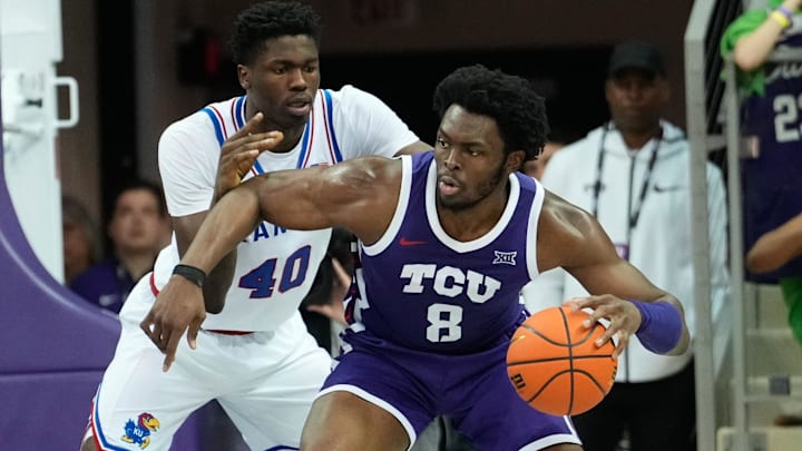 Jan 22, 2025; Fort Worth, Texas, USA;  TCU Horned Frogs center Ernest Udeh Jr. (8) controls the ball as Kansas Jayhawks forward Flory Bidunga (40) defends during the second half at Ed and Rae Schollmaier Arena. Mandatory Credit: Chris Jones-Imagn Images