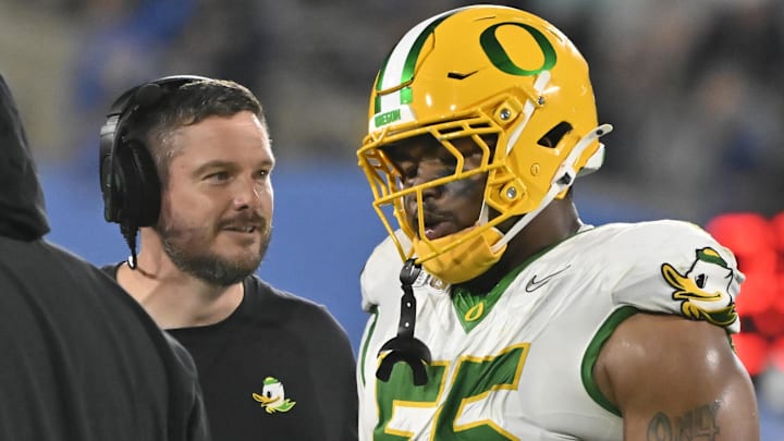 Sep 28, 2024; Pasadena, California, USA; Oregon Ducks head coach Dan Lanning talks to Oregon Ducks defensive lineman Derrick Harmon (55) during the fourth quarter at Rose Bowl. Mandatory Credit: Robert Hanashiro-Imagn Images