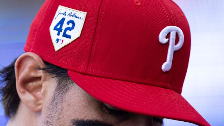 Philadelphia Phillies player wears a Phillies hat with the No. 24 on the side before a game.
