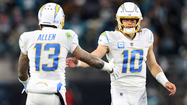 Jan 14, 2023; Jacksonville, Florida, USA; Los Angeles Chargers quarterback Justin Herbert (10) and wide receiver Keenan Allen (13) celebrate after a play during the second quarter a wild card game against the Jacksonville Jaguars at TIAA Bank Field. 