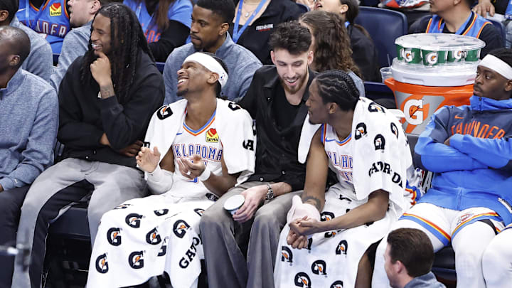 Feb 5, 2025; Oklahoma City, Oklahoma, USA; Oklahoma City Thunder guard Cason Wallace (22), guard Shai Gilgeous-Alexander (2), forward Chet Holmgren (7) and forward Jalen Williams (8) watch the game against the Phoenix Suns from the bench during the fourth quarter of a game at Paycom Center. Mandatory Credit: Alonzo Adams-Imagn Images Feb 5, 2025; Oklahoma City, Oklahoma, USA; Oklahoma City Thunder guard Cason Wallace (22), guard Shai Gilgeous-Alexander (2), forward Chet Holmgren (7) and forward Jalen Williams (8) watch the game against the Phoenix Suns from the bench during the fourth quarter of a game at Paycom Center. Mandatory Credit: Alonzo Adams-Imagn Images
