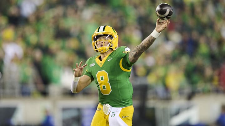Nov 9, 2024; Eugene, Oregon, USA; Oregon Ducks quarterback Dillon Gabriel (8) throws a touchdown pass during the first half against the Maryland Terrapins at Autzen Stadium. Mandatory Credit: Troy Wayrynen-Imagn Images