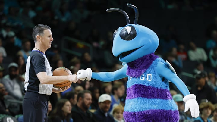 Dec 15, 2023; Charlotte, North Carolina, USA; Hugo, the Charlotte Hornets mascot, fist bumps referee