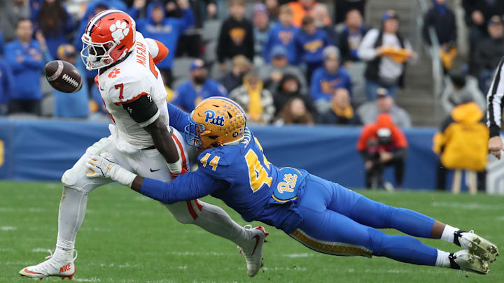 Nov 16, 2024; Pittsburgh, Pennsylvania, USA;  Pittsburgh Panthers defensive lineman Jimmy Scott (44) forces Clemson Tigers running back Phil Mafah (7) to fumble during the fourth quarter at Acrisure Stadium. Mandatory Credit: Charles LeClaire-Imagn Images