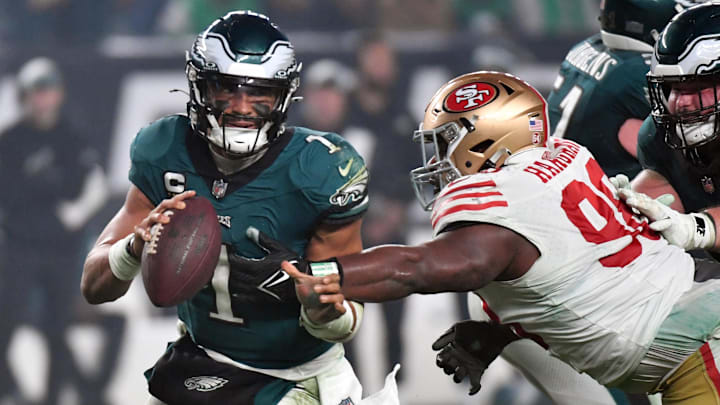 Dec 3, 2023; Philadelphia, Pennsylvania, USA; Philadelphia Eagles quarterback Jalen Hurts (1) is tackled by San Francisco 49ers defensive tackle Javon Hargrave (98) during the fourth quarter at Lincoln Financial Field. Mandatory Credit: Eric Hartline-Imagn Images