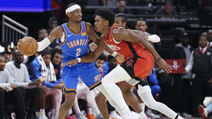 Dec 1, 2024; Houston, Texas, USA; Oklahoma City Thunder guard Shai Gilgeous-Alexander (2) controls the ball as Houston Rockets forward Amen Thompson (1) defends during the game at Toyota Center. Mandatory Credit: Troy Taormina-Imagn Images Dec 1, 2024; Houston, Texas, USA; Oklahoma City Thunder guard Shai Gilgeous-Alexander (2) controls the ball as Houston Rockets forward Amen Thompson (1) defends during the game at Toyota Center. Mandatory Credit: Troy Taormina-Imagn Images