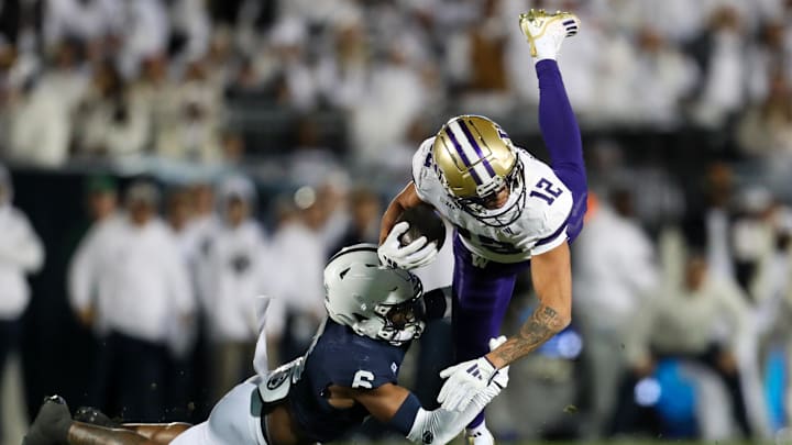 Nov 9, 2024; University Park, Pennsylvania, USA; Washington Huskies wide receiver Denzel Boston (12) runs with the ball against Penn State Nittany Lions safety Zakee Wheatley (6) during the first quarter at Beaver Stadium. Mandatory Credit: Matthew O'Haren-Imagn Images Nov 9, 2024; University Park, Pennsylvania, USA; Washington Huskies wide receiver Denzel Boston (12) runs with the ball against Penn State Nittany Lions safety Zakee Wheatley (6) during the first quarter at Beaver Stadium. Mandatory Credit: Matthew O'Haren-Imagn Images