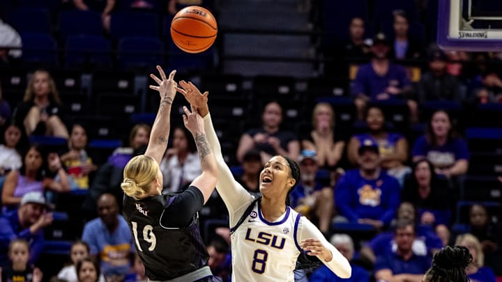 Nov 8, 2024; Baton Rouge, Louisiana, USA;  LSU Lady Tigers forward Jersey Wolfenbarger (8) blocks a shot by Northwestern State Lady Demons guard Sharna Ayres (19) during the first half at Pete Maravich Assembly Center. Mandatory Credit: Stephen Lew-Imagn Images