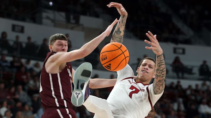 Mississippi State forward Sergej Macura (11) and Arkansas forward Trevon Brazile (7) battle for a rebound during the second half at Humphrey Coliseum. 