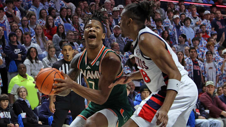 Dec 2, 2025; Oxford, Mississippi, USA; Miami Hurricanes forward Shelton Henderson (7) drives to the basket as Mississippi Rebels forward Augusto Cassiá (88) defends during the first half at The Sandy and John Black Pavilion at Ole Miss. Mandatory Credit: Petre Thomas-Imagn Images