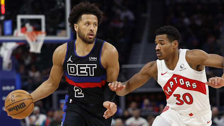 Mar 13, 2024; Detroit, Michigan, USA;  Detroit Pistons guard Cade Cunningham (2) dribbles the ball against  Toronto Raptors guard Ochai Agbaji (30) in the first half at Little Caesars Arena. Mandatory Credit: Rick Osentoski-Imagn Images