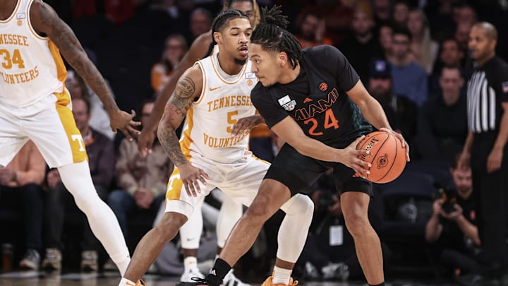 Dec 10, 2024; New York, New York, USA;  Miami Hurricanes guard Nijel Pack (24) looks to drive past Tennessee Volunteers guard Zakai Zeigler (5) in the first half at Madison Square Garden. Mandatory Credit: Wendell Cruz-Imagn Images