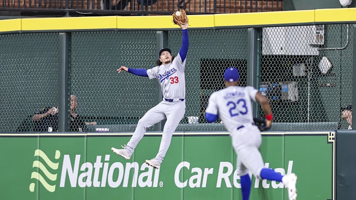 Jul 27, 2024; Houston, Texas, USA; Los Angeles Dodgers center fielder James Outman (33) makes a leaping catch at the wall during the fourth inning against the Houston Astros at Minute Maid Park. Mandatory Credit: Troy Taormina-Imagn Images