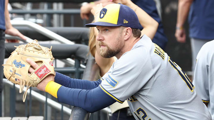 Jul 2, 2025; New York City, New York, USA;  Milwaukee Brewers first baseman Rhys Hoskins (12) watches from the dugout prior to game against the New York Mets at Citi Field.