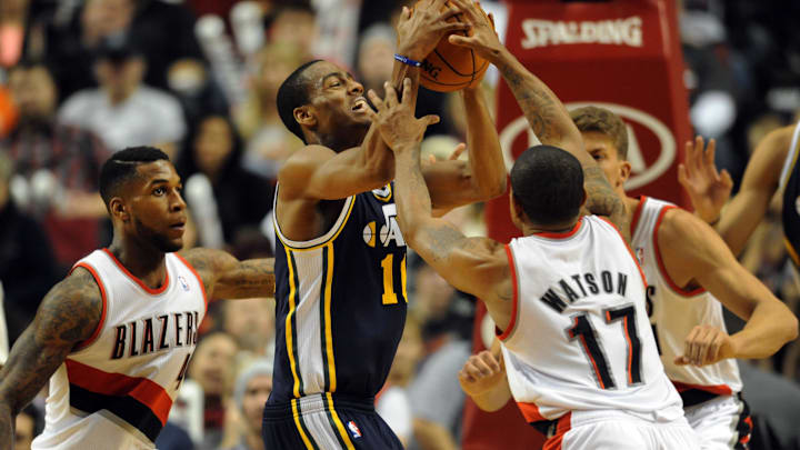 Dec 6, 2013; Portland, OR, USA; Utah Jazz point guard Alec Burks (10) and Portland Trail Blazers point guard Earl Watson (17) battle for a loose ball during the fourth quarter of the game at the Moda Center. The Blazers won the game 130-98. Mandatory Credit: Steve Dykes-Imagn Images