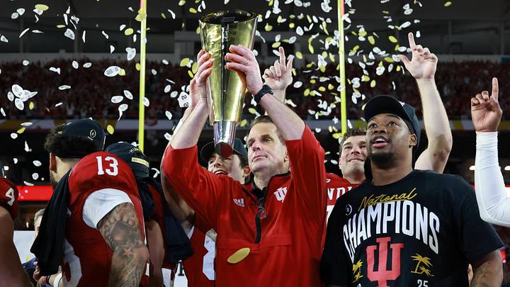 Jan 19, 2026; Miami Gardens, FL, USA; Indiana Hoosiers head coach Curt Cignetti hoists the National Championship trophy in the air after the College Football Playoff National Championship game at Hard Rock Stadium. Mandatory Credit: Mark J. Rebilas-Imagn Images