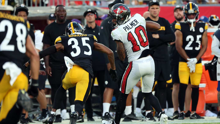 Aug 11, 2023; Tampa, Florida, USA; Tampa Bay Buccaneers wide receiver Trey Palmer (10) catches the ball as Pittsburgh Steelers cornerback Luq Barcoo (35) defends during the first half at Raymond James Stadium. Mandatory Credit: Kim Klement Neitzel-USA TODAY Sports