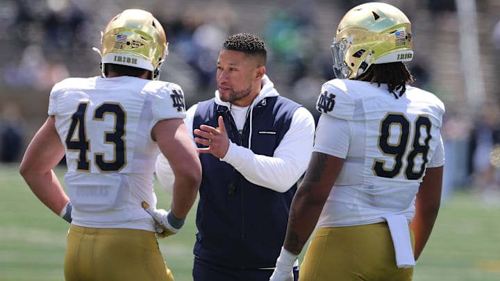 Notre Dame Head Coach Marcus Freeman speaks to Kahanu Kia (43) and Devan Houstan (98) Saturday, April 20, 2024, at the annual Notre Dame Blue-Gold spring football game at Notre Dame Stadium in South Bend.