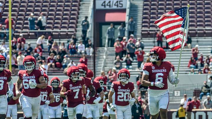 Oklahoma defensive lineman Nigel Smith carries the American flag before the spring game. Oklahoma defensive lineman Nigel Smith carries the American flag before the spring game.