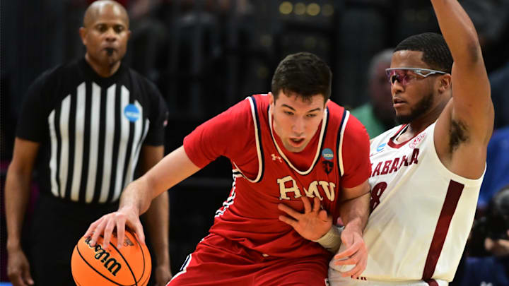 Mar 21, 2025; Cleveland, OH, USA; Robert Morris Colonials forward Alvaro Folgueiras (7) plays the ball defense day Alabama Crimson Tide guard Chris Youngblood (8) in the second half during the NCAA Tournament First Round at Rocket Arena. Mandatory Credit: Ken Blaze-Imagn Images