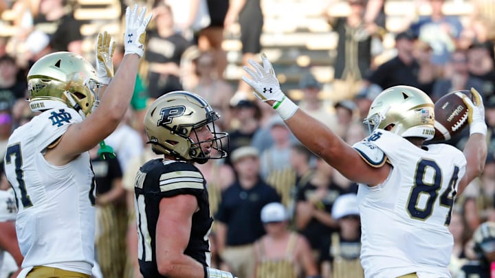 Notre Dame Fighting Irish tight end Cooper Flanagan (87) and Notre Dame Fighting Irish tight end Kevin Bauman (84) celebrates in front of Purdue Boilermakers defensive back Dillon Thieneman (31) after a Notre Dame Fighting Irish touchdown Saturday, Sept. 14, 2024, during the NCAA football game at Ross-Ade Stadium in West Lafayette, Ind. Notre Dame Fighting Irish won 66-7.