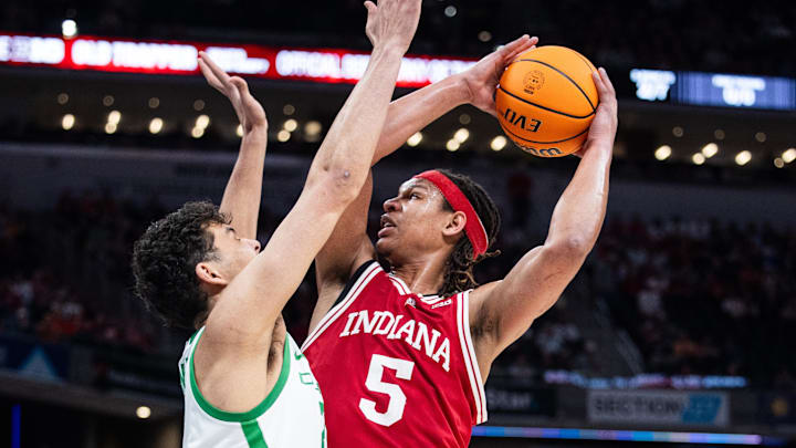 Mar 13, 2025; Indianapolis, IN, USA; Indiana Hoosiers forward Malik Reneau (5) shoots the ball while Oregon Ducks forward Brandon Angel (21) defends in the first half at Gainbridge Fieldhouse. Mandatory Credit: Trevor Ruszkowski-Imagn Images